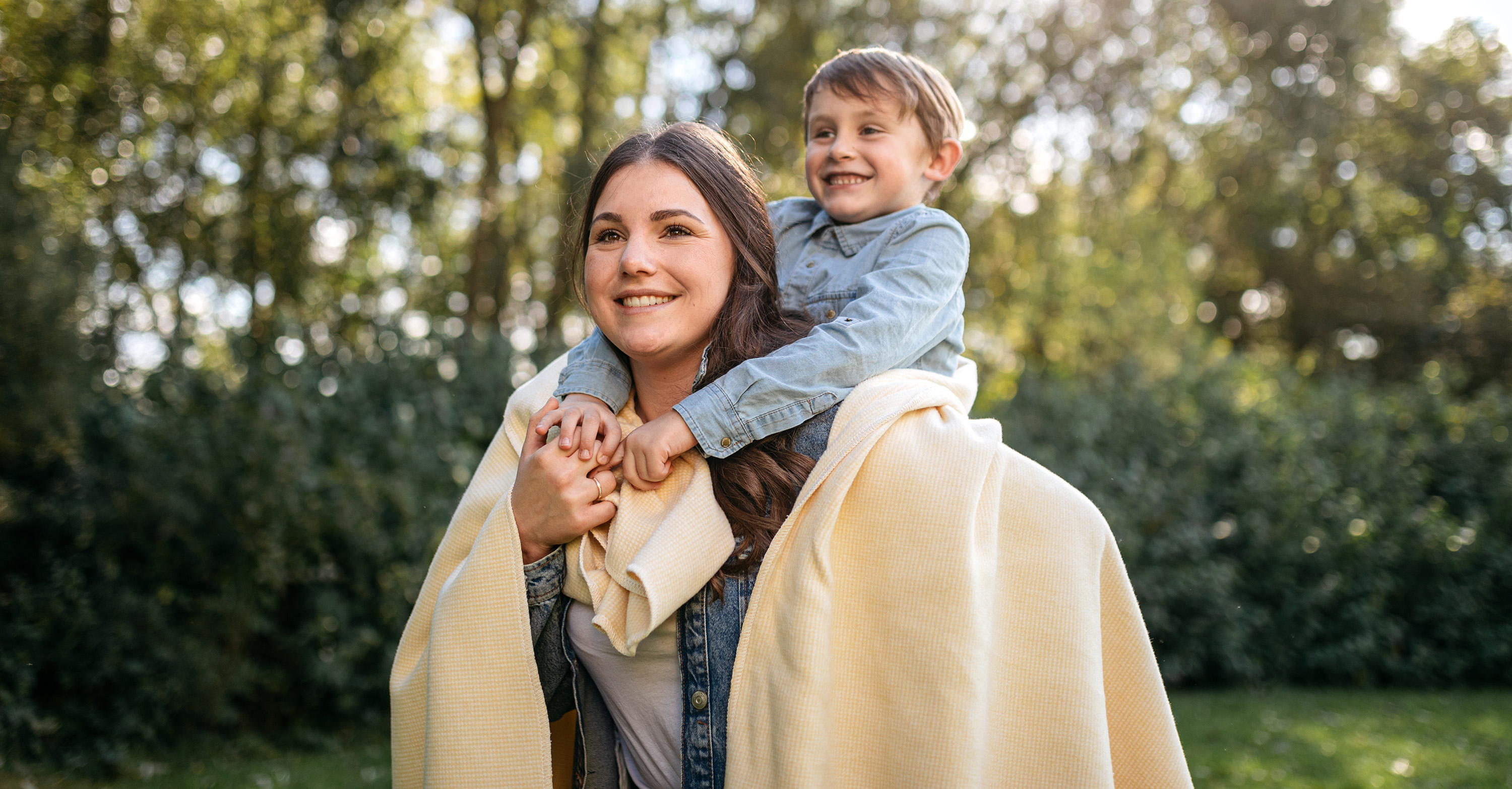 Mutter und Kind mit gelber Baumwolldecke